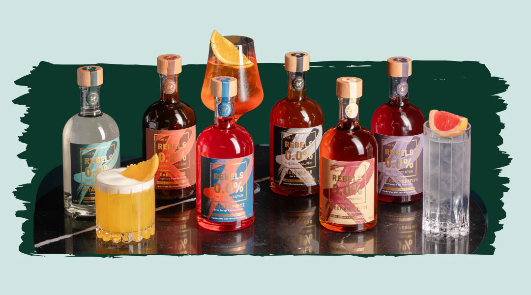 Collection of all of Rebels 0.0% non-alcoholic spirits with thee glasses in between with a drink poured in
